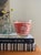 Fabulous glass ice bucket, made in the 1960s, a coral pink band through the center with a silhouette of pagodas and white,...