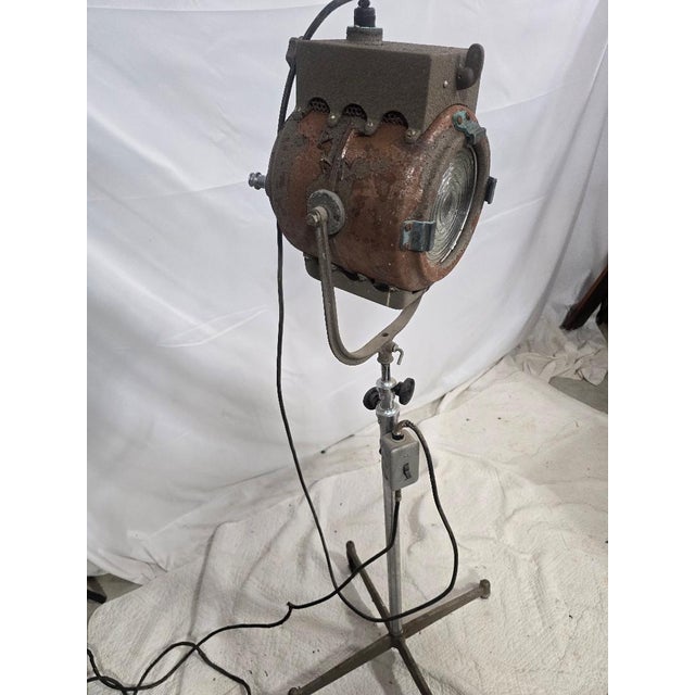 A striking mid-century industrial stage light by Ward Leonard Electric Co., mounted on an adjustable rolling stand....