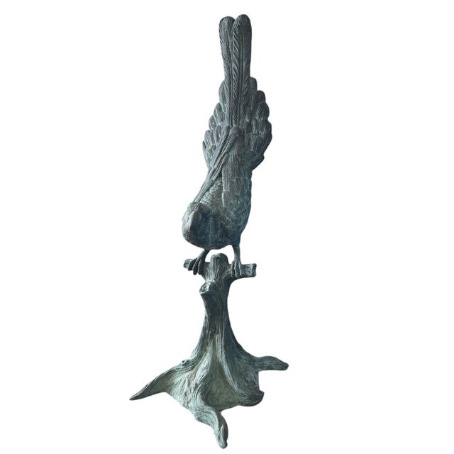 Make a soaring statement with this monumental 51-inch tall sculpture of a parrot perched upon a naturalistic tree stump....