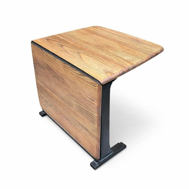 A beautifully designed drop-leaf coffee table by Ercol , crafted in solid elm with a sculptural base and gently rounded...