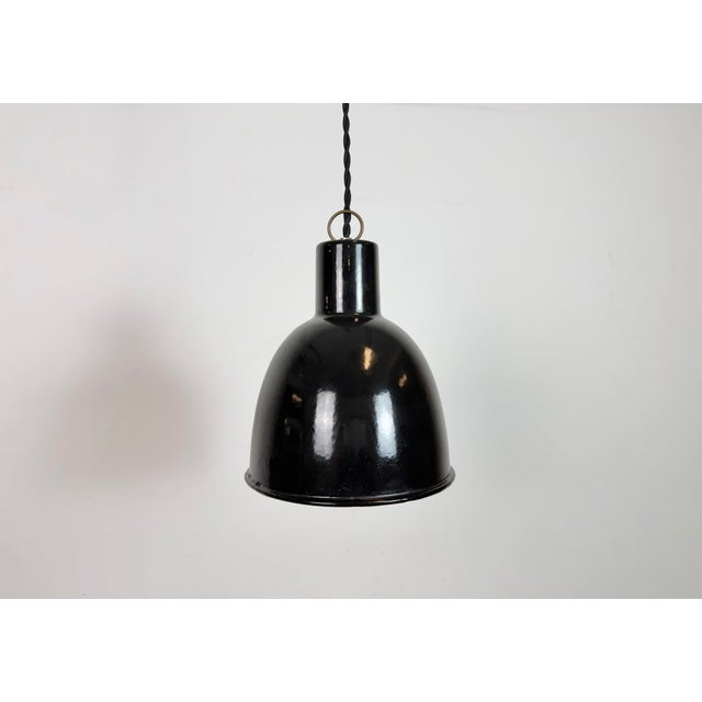 Industrial black enamel pendant light made in former Czechosloivakia during the 1950s. White enamel inside the shade....