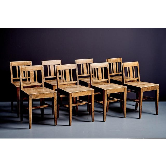 Set of eight birchwood chairs by Tranås Snickerifabrik, with square seats, straight legs joined by stretchers, and simple...