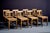 Set of eight birchwood chairs by Tranås Snickerifabrik, with square seats, straight legs joined by stretchers, and simple...