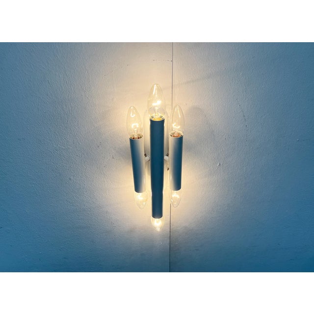 Simple Space Age wall lamp of Italian origin. A timeless design that impresses with its simple and precise geometry. Three...