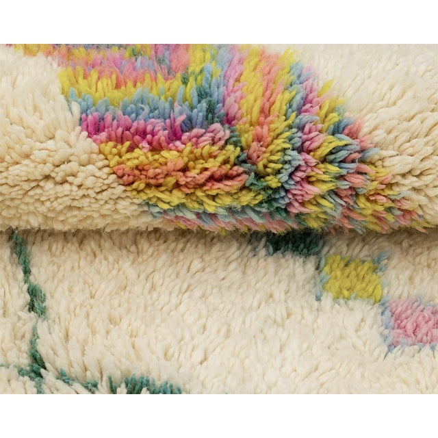 A striped diamond bursts in candy-bright color at the top of this cream rug, showering tiny confetti-like squares of pink,...