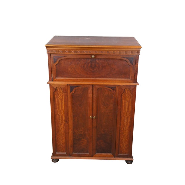 Antique burl walnut record cabinet or console featuring drop front and flip top that open to access the top compartment....
