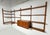 Midcentury "Cado " style wall-mounted shelving unit in teak, circa 1960s, from the "Veggen de Luxe" line, designed by...