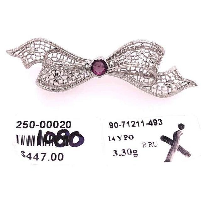 14 Karat White Gold Brooch Filigree Bow Design With Amethyst Center Stone Pin. 3.30 grams total weight.