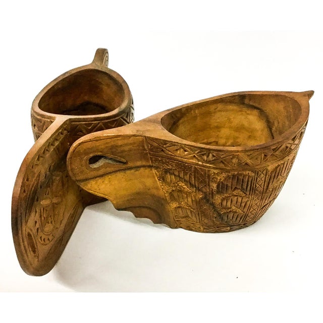 An Antique Scandinavian folk art wooden jug, commonly referred to as a 'Nordic wedding cup', hand carved with wheels,...