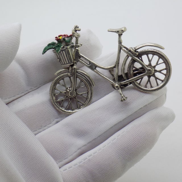 A charming and nostalgic miniature, this vintage Italian silver piece depicts a bicycle with a delicate flower basket,...