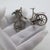 A charming and nostalgic miniature, this vintage Italian silver piece depicts a bicycle with a delicate flower basket,...