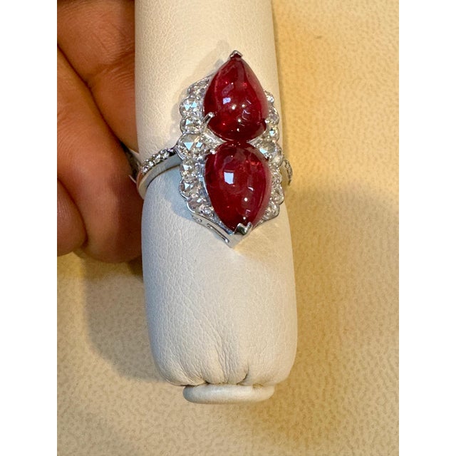 Introducing a timeless classic, the Cocktail Ring features a stunning 7 Ct Finest Rubelite with 2 Cabochons in pear shape...