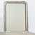 A French 19th century Louis Philippe mantel mirror in an arched, silver gilt frame enhanced by dark oxidation and...