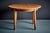 Round dining table in solid oak, finished in a warm, honey tone. The thick circular top sits on a simple apron with four...