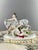 Large Capodimonte Porcelain Figurine Charming polychrome porcelain composition depicting two putti playing with a donkey....