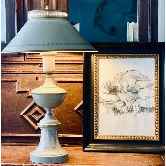 A pretty vintage French-style tole metal lamp in a coveted neutral tan color with hand-painted Napoleonic laurel victory...