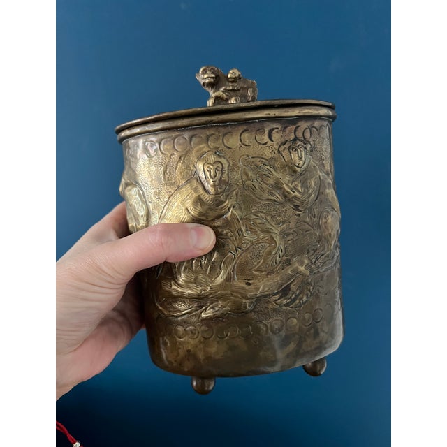 This remarkable vintage brass canister features detailed raised relief work of monkeys in a jungle setting, wrapped around...
