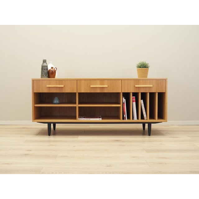 The sideboard was made in Scandinavian style. The structure is covered with oak veneer. Legs made of solid wood stained...