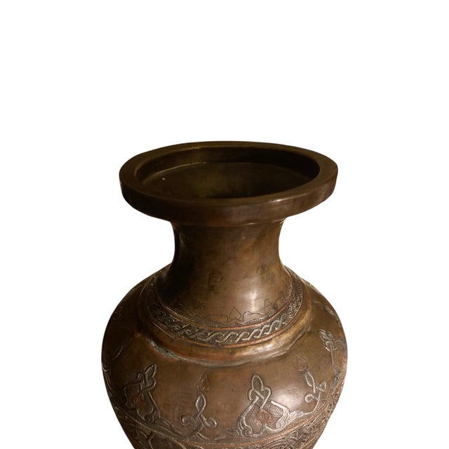 A beautifully hand-decorated vintage urn-form vase featuring raised silver and copper inlay over a richly patinated brass...