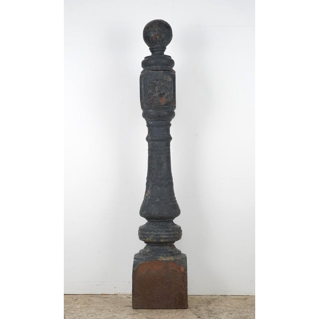 Victorian newel posts made of cast iron with large ball finials and multiple embossed floral rosettes. It is in a...
