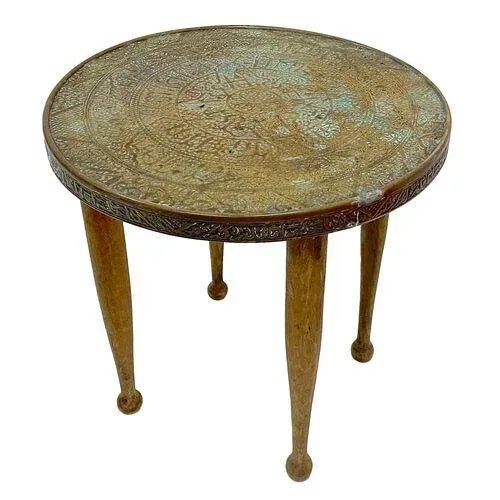 Vintage Moroccan style footstool with brass clad top embossed with geometric designs. No maker's marks.
