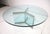 A glamorous round plateglass coffee table with three panel matching base having heavy chrome accent strips to the tops and...