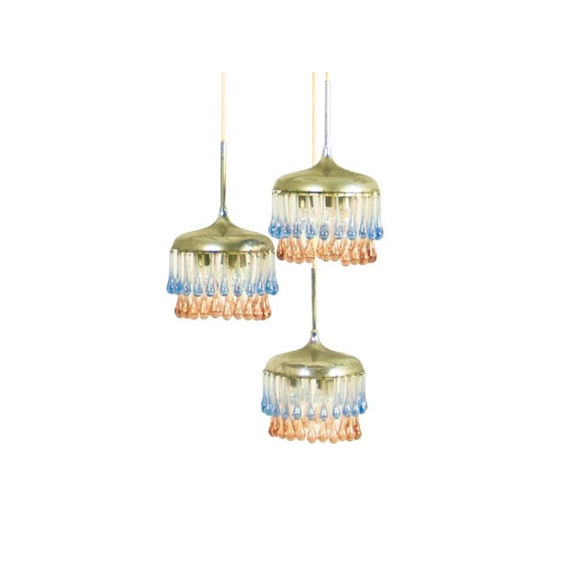 A rare and elegant pendant lamp produced by Stilnovo in the 1950s. It consists in 3 hanging shades with a Murano pendant...