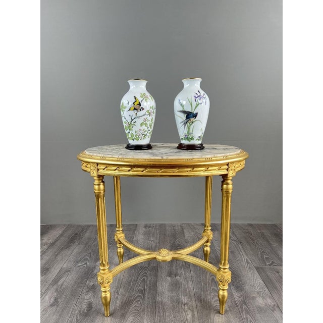 An elegant pair of fine porcelain vases from the Franklin Porcelain factory, entitled “The Meadowland Bird Vase,” based on...