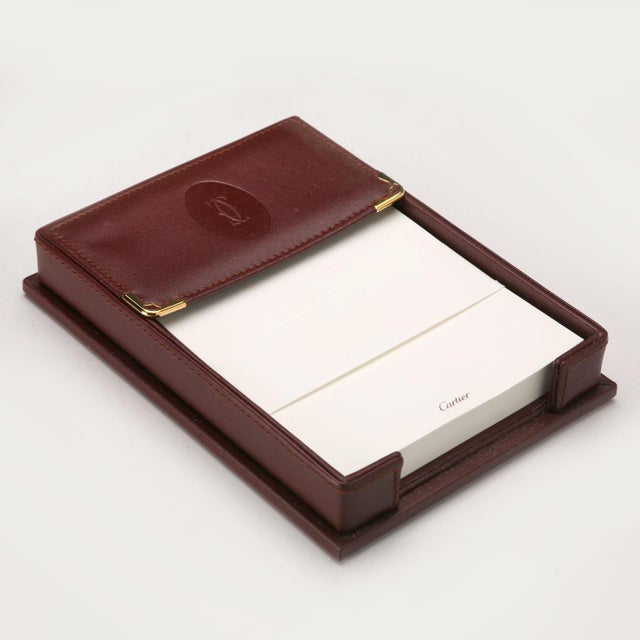 Les Must de Cartier leather stationery holder. Comes with original box and warranty. This piece is attributed to the...