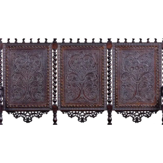 Three seat sofa Portuguese from the 19th century, in carved chestnut wood. Seat in carved leather with pleating, roll-up...