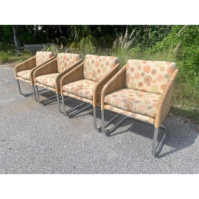 A fine set of four mid-century wicker bucket chairs with cantilever chrome tubular frame. In the manner of Fabricius and...