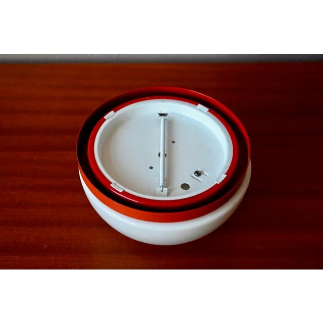 This pretty vintage wall lamp is made of white glass. It can be used as a wall or ceiling light. Its hemispherical shape...