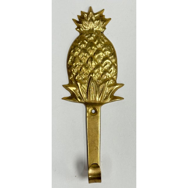 Vintage brass pineapple motif wall hook. Patina. Hole for hanging. No hardware.