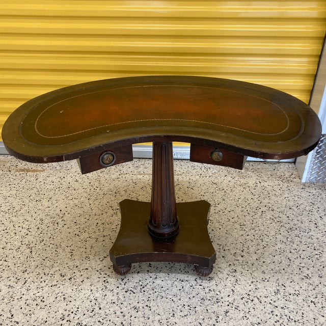 An unusual and lovely kidney shaped occasional table with two drawers and two small slide out trays by Maslow Freen of New...