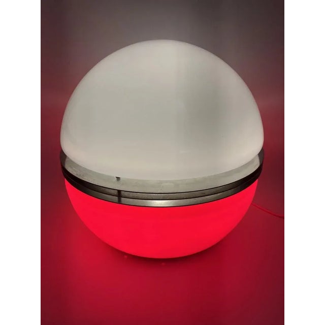 A lamp *large table lamp *in a spherical shape *separated in the middle by three chrome slats. *white satin glass. The...