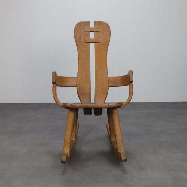 A rare brutalist rocking chair by belgian designer de puydt, crafted in solid oak with striking joinery and sculptural...