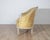 A beautiful and refined French Louis XVI style canapé, 20th century, featuring an elegantly carved painted frame and...