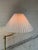 This elegant floor lamp features an adjustable swing arm and a classic pleated shade that casts a warm ambient glow....