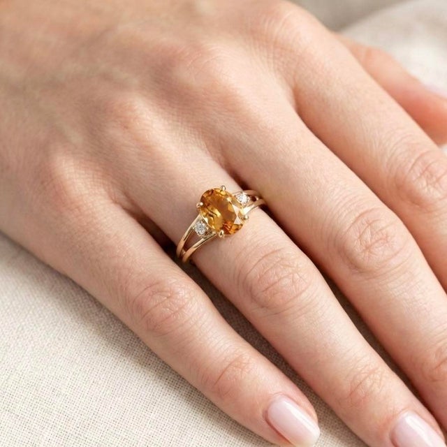 Bask in the warm, sun-kissed glow of this magnificent three-stone cocktail ring, a masterful combination of modern...