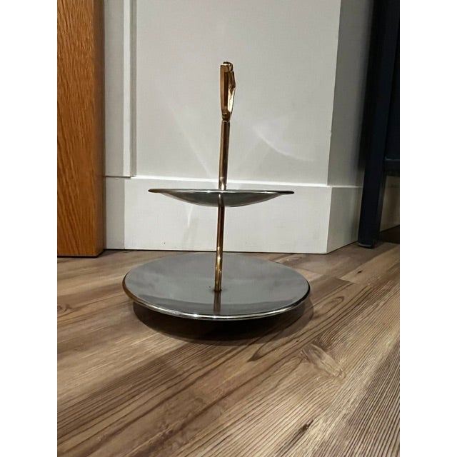 This item is a vintage two-tier tidbit or serving tray, by mid-century modern design brand Kromex, featuring two round...