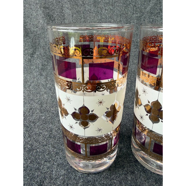 Vintage MCM, set of 4 Culver LTD, 22 Kt gold starburst pattern highball glasses. Glasses are accented with gold, purple...