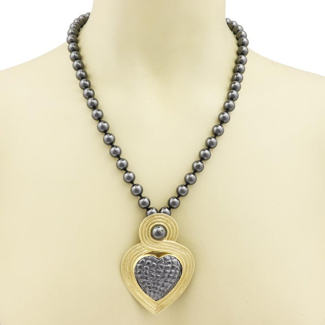 This large eye catching necklace by designer Gucci, the large heart pendant can be converted from a pendant to a brooch,...