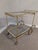 Beautiful glass and brass bar cart. The glass top has a mirrored edge. Wheels roll well.