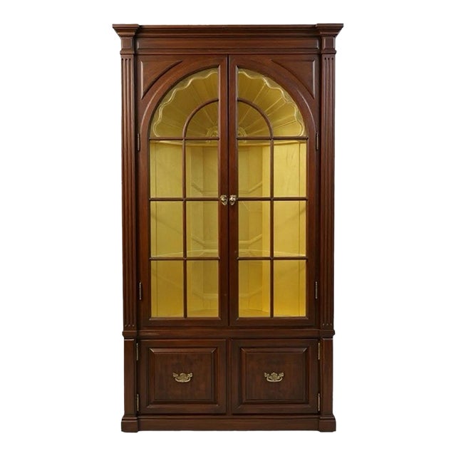 It is an English Georgian style carved mahogany corner cabinet with carved shell motif. It has glass panel doors and vivid...