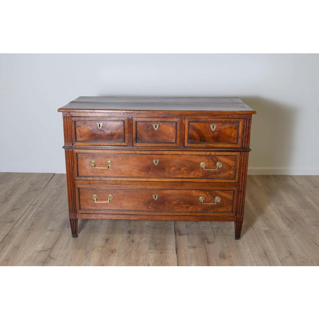 This Louis XV chest of drawers in walnut combines timeless elegance with practical functionality, making it a...