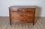 This Louis XV chest of drawers in walnut combines timeless elegance with practical functionality, making it a...