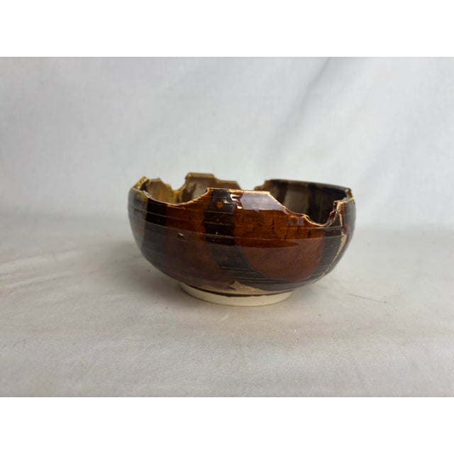 A brilliant earthy bowl. Created by artist Flynn Sochon, this beautiful piece would add visual interest and texture to any...