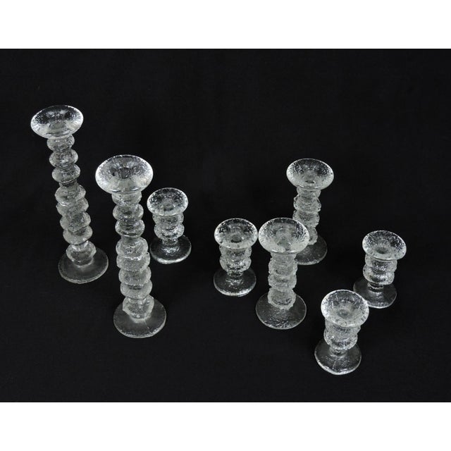 Beautiful set of 8 Festivo glass candlesticks designed by Timo Sarpaneva and manufactured in Finland by Iittala. This set...
