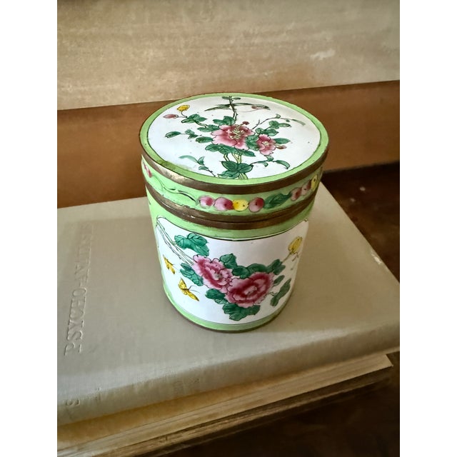This charming vintage Canton enamel covered box features hand-painted pink peony blossoms accented by green foliage and...