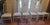 A set of six Abel Gonzalez white lacquer tall-back modern dining room chairs with white textured cushion seats. Three have...